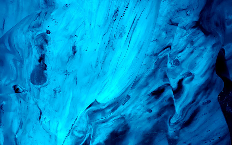 Abstract photograph of blue-toned ice from the inside of an Icelandic ice cave.